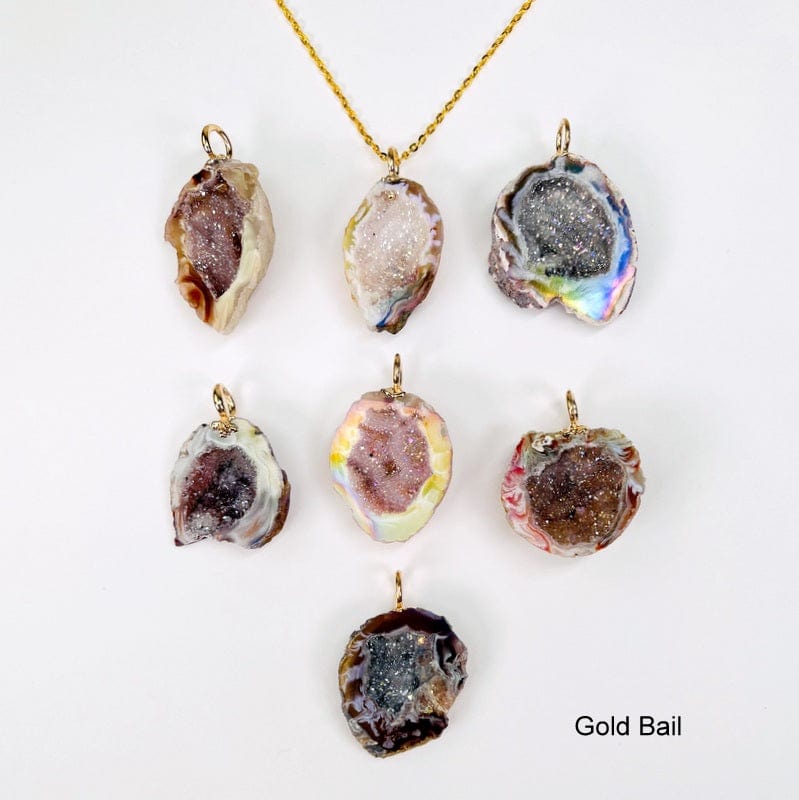 geode pendants with an electroplated gold bail displayed to show the differences in the possible sizes