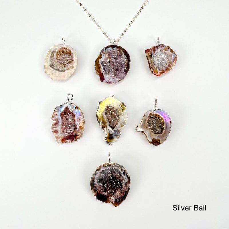geode pendants with an electroplated silver bail displayed to show the differences in the possible sizes