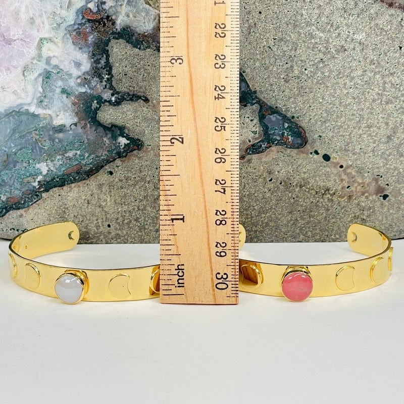 bracelets next to a ruler for size reference 