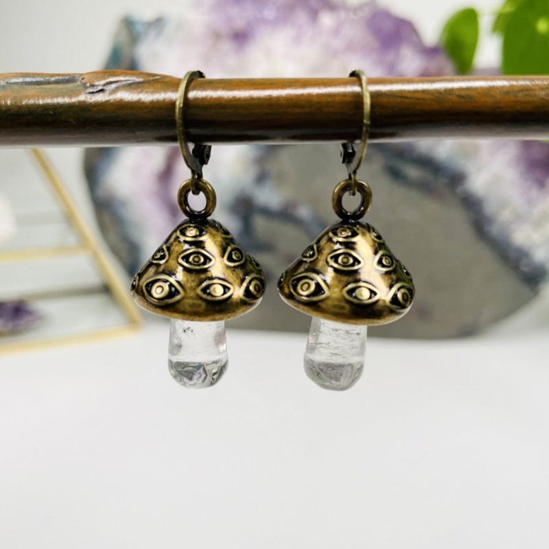 close up of the antique gold evil eye mushroom earrings 
