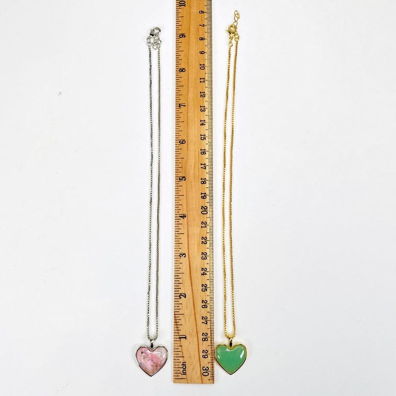 necklaces next to a ruler for size reference 