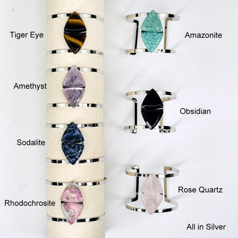 close up of all the silver cuff bracelets showing the different gemstones . available in tiger eye, amethyst, sodalite, rhodochrosite, amazonite, obsidian, and rose quartz 