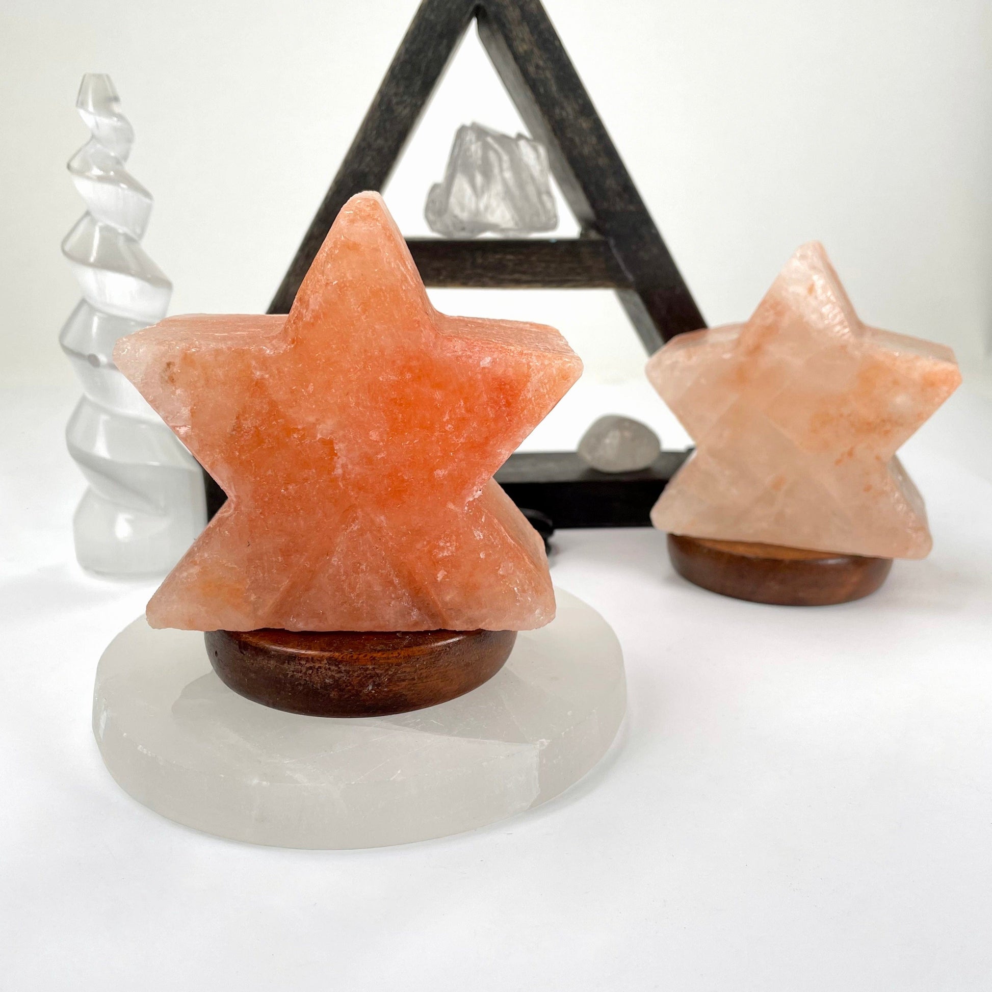 himalayan salt orange star lamp on display in front of backdrop