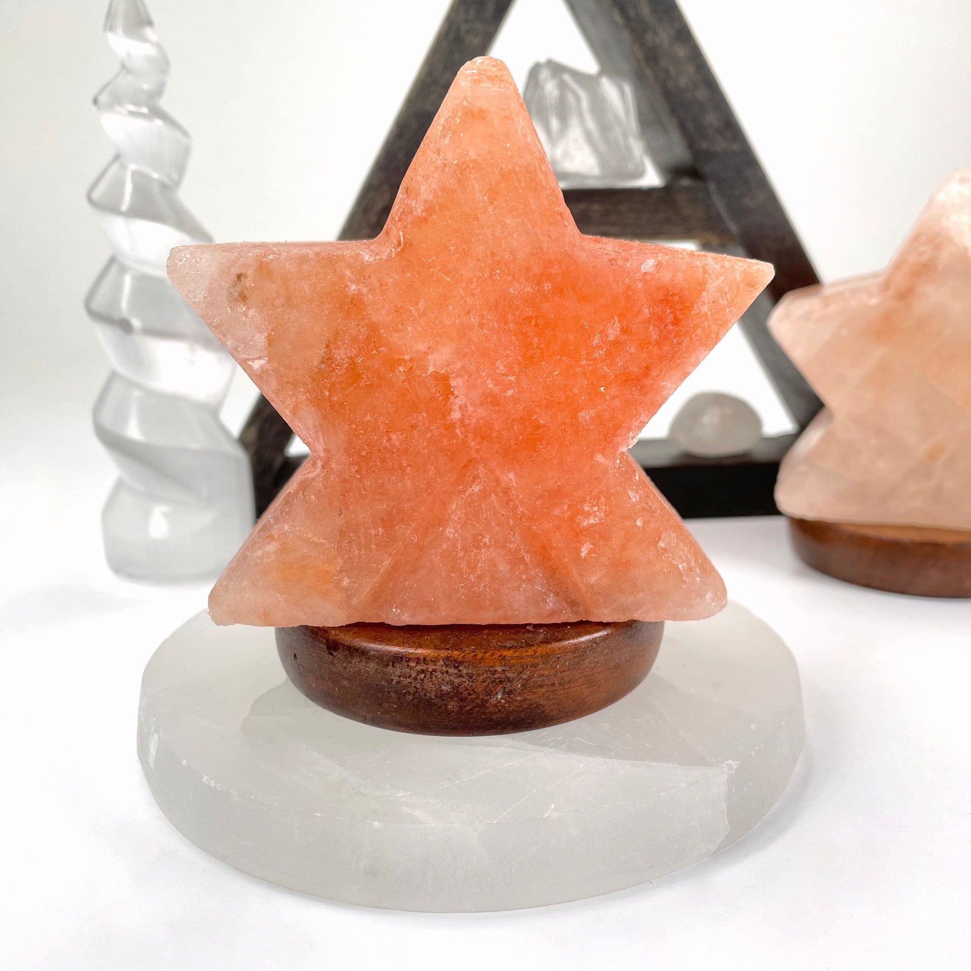 close up of himalayan salt orange star lamp in front of backdrop for details