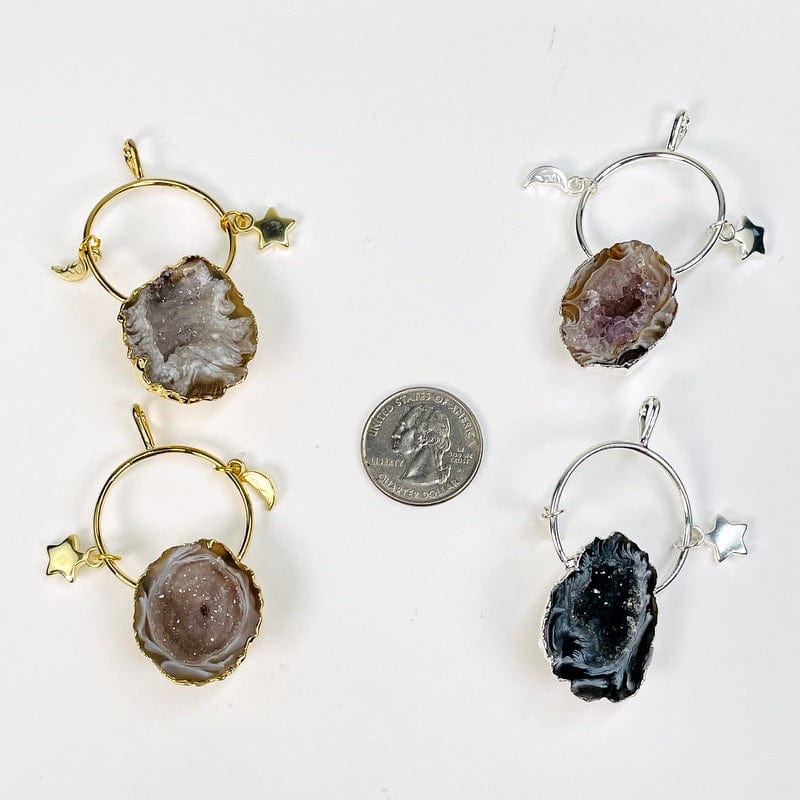 pendants next to a quarter for size reference 