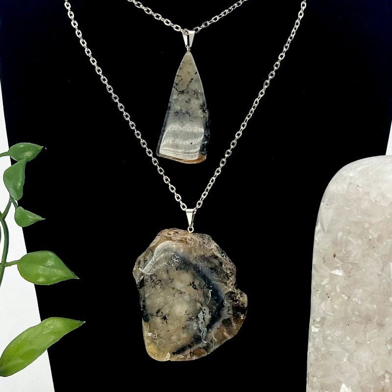 dendritic opal slabs displayed on a chain 