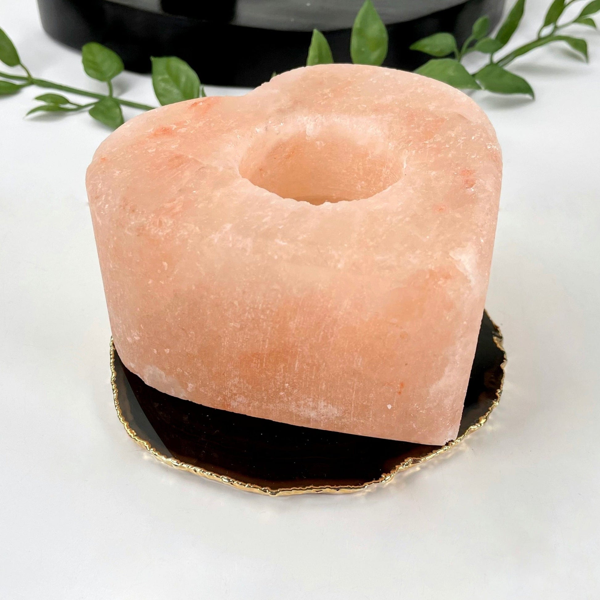 angled view of himalayan salt orange heart candle holder for details