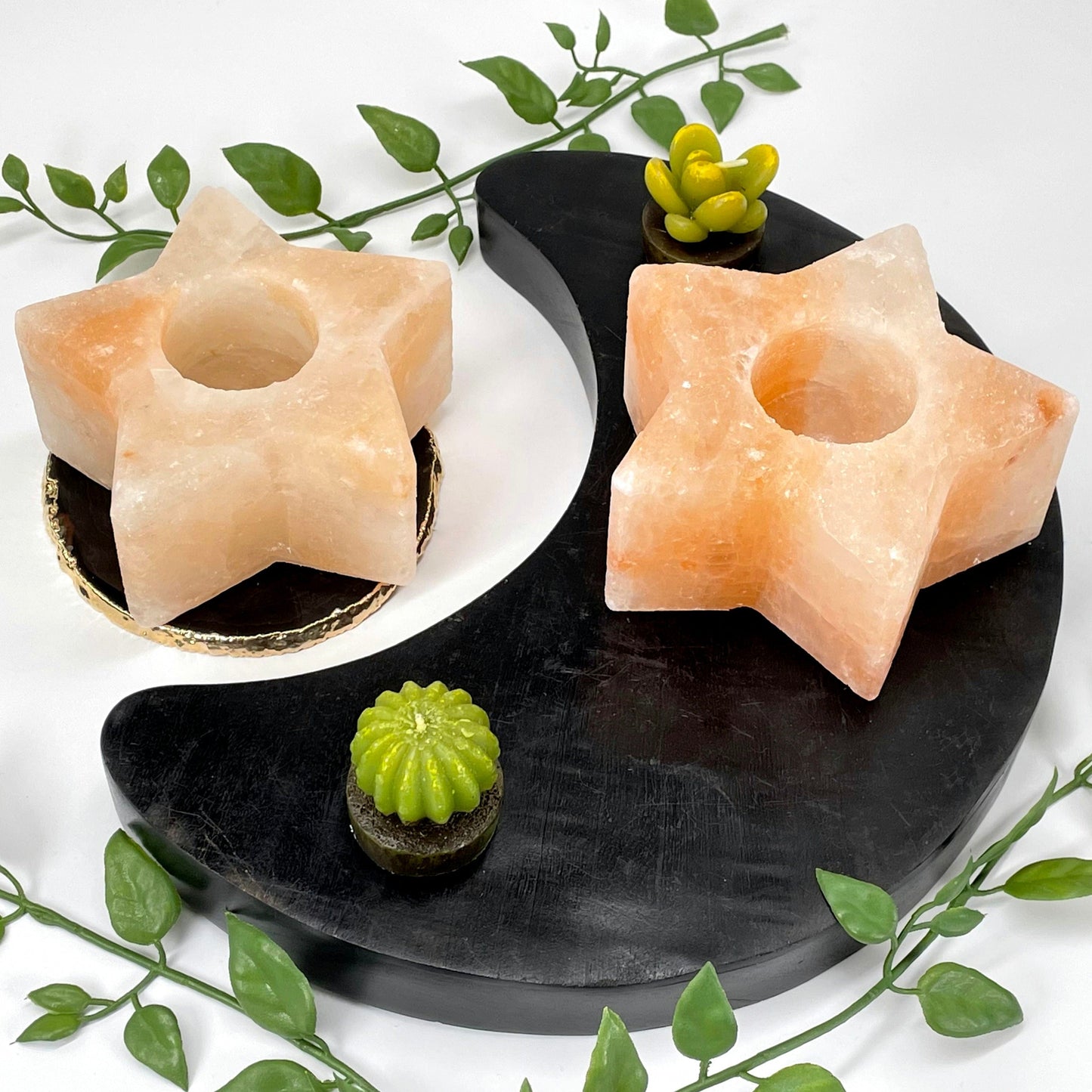angled view of two himalayan salt orange star candle holders on display