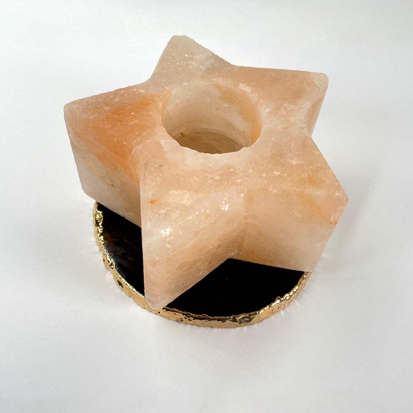 close up of himalayan salt orange star candle holder for details