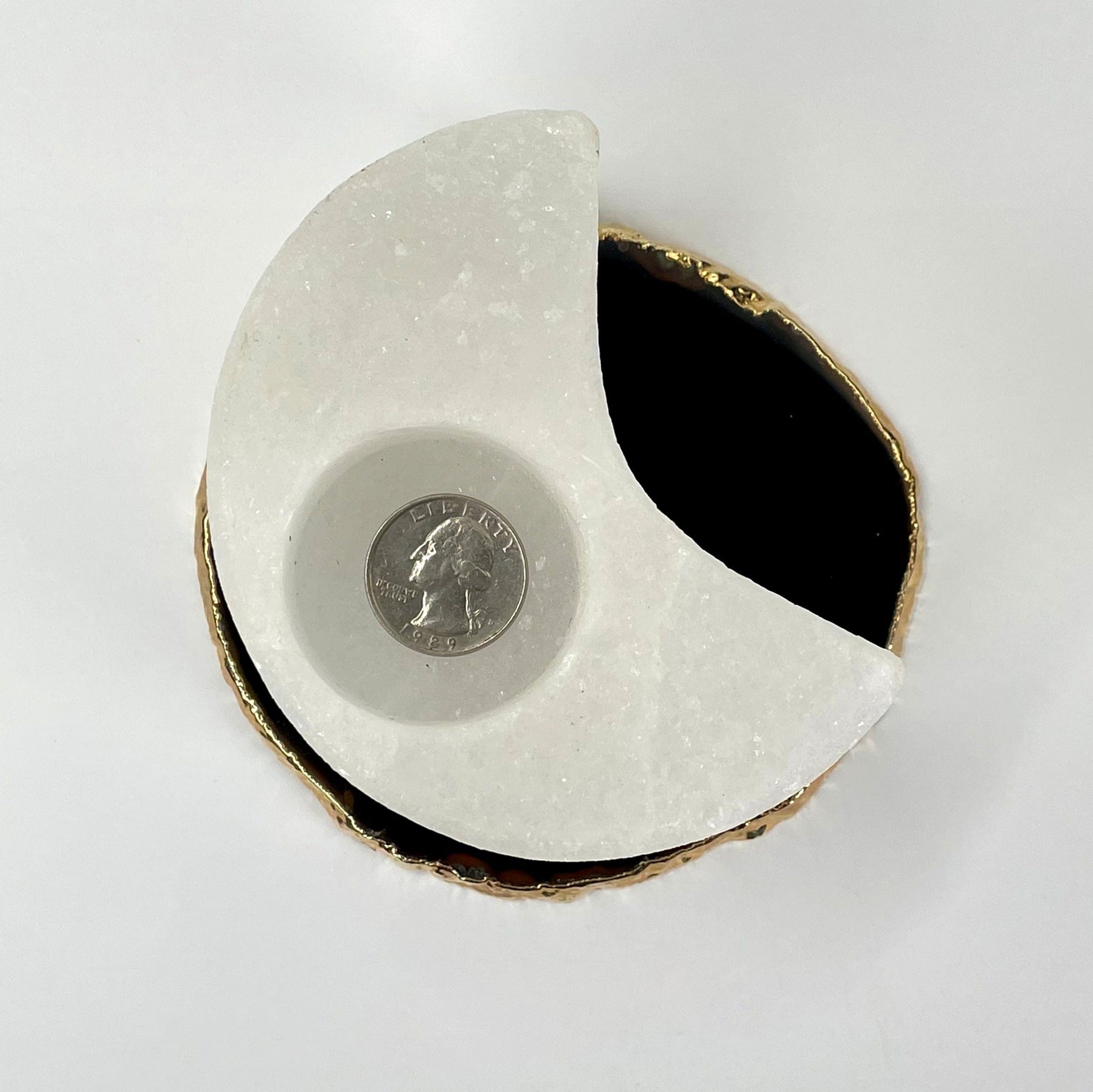 overhead view of himalayan salt white moon candle holder with quarter for size reference