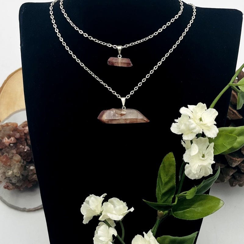 double terminated lithium quartz point pendant with silver bail displayed on chain 