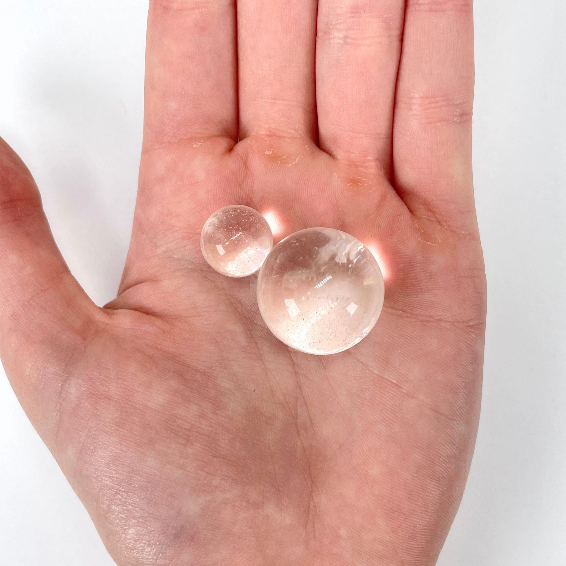 close up of approximate smallest and largest crystal quartz spheres for possible variations