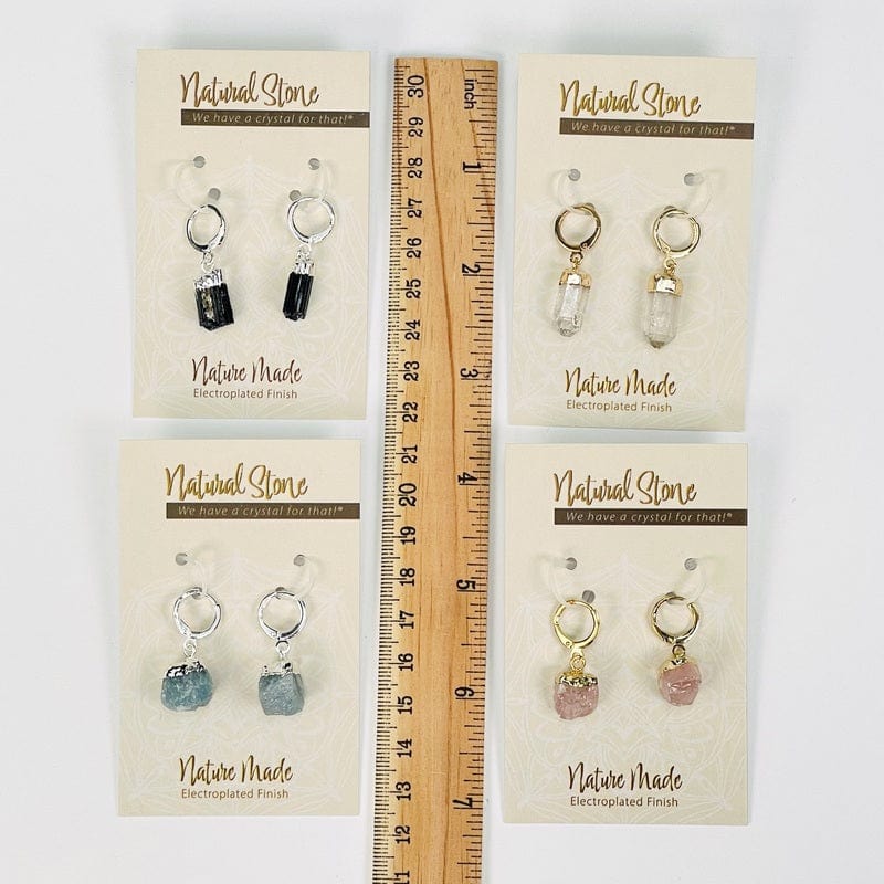 earrings next to a ruler for size reference 