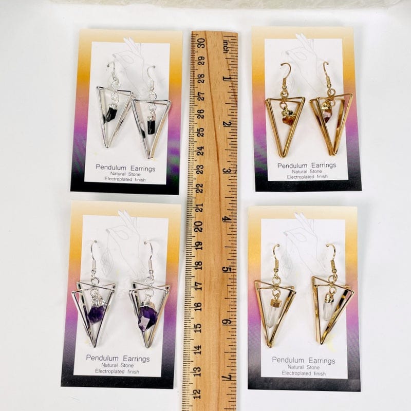 earrings next to a ruler for size reference 