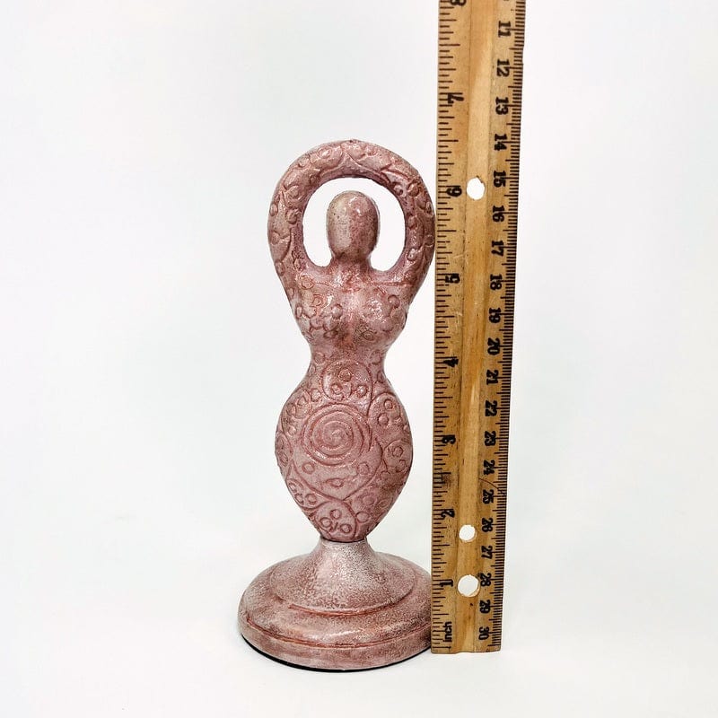 earth goddess next to a ruler for size reference 
