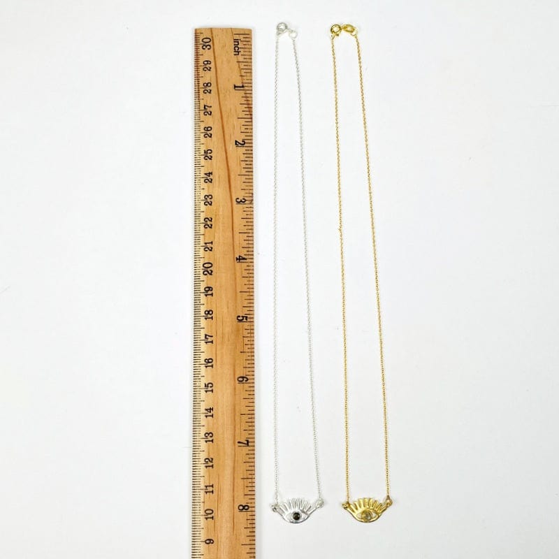 necklaces next to a ruler for size reference 
