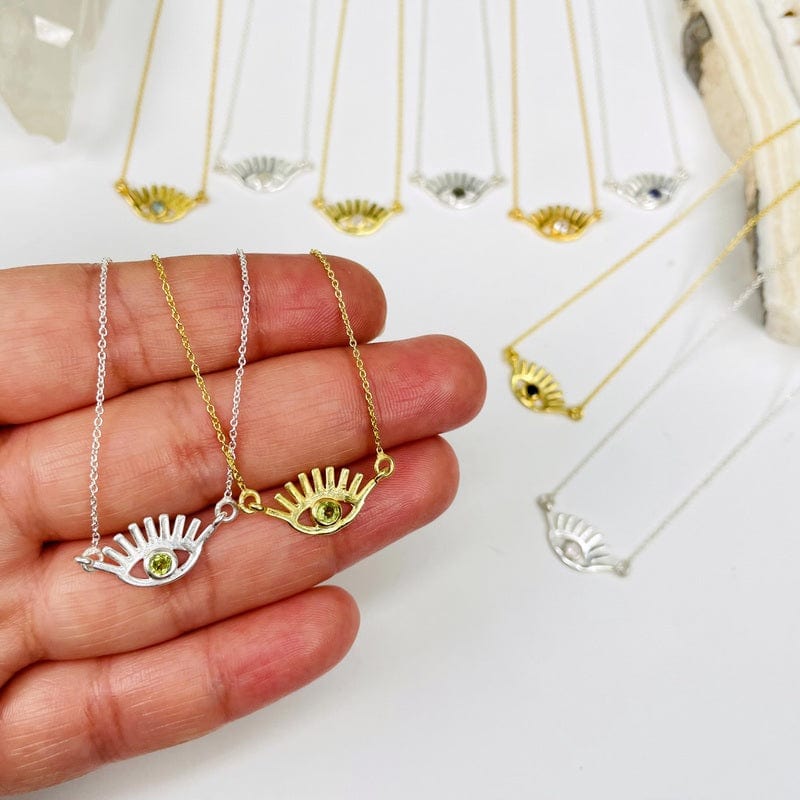 evil eye necklace pendants in hand for size reference 