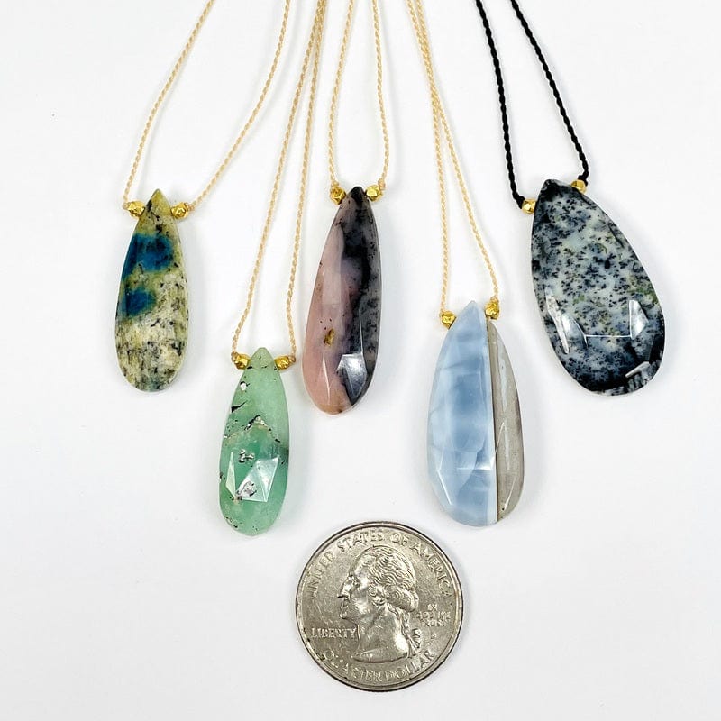 pendant next to a quarter for size reference 