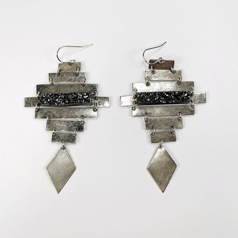 silver earrings with a diamond shape at the bottom with a black diamond druzy bar that accents the center