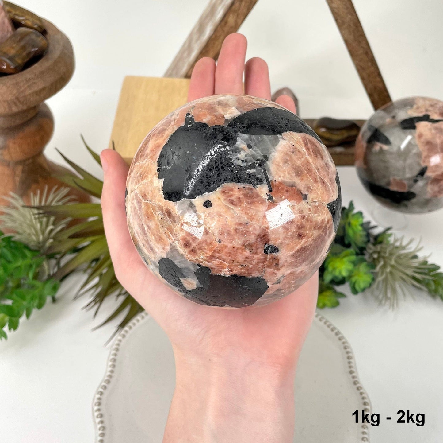 one 1kg - 2kg sphere in hand for size reference