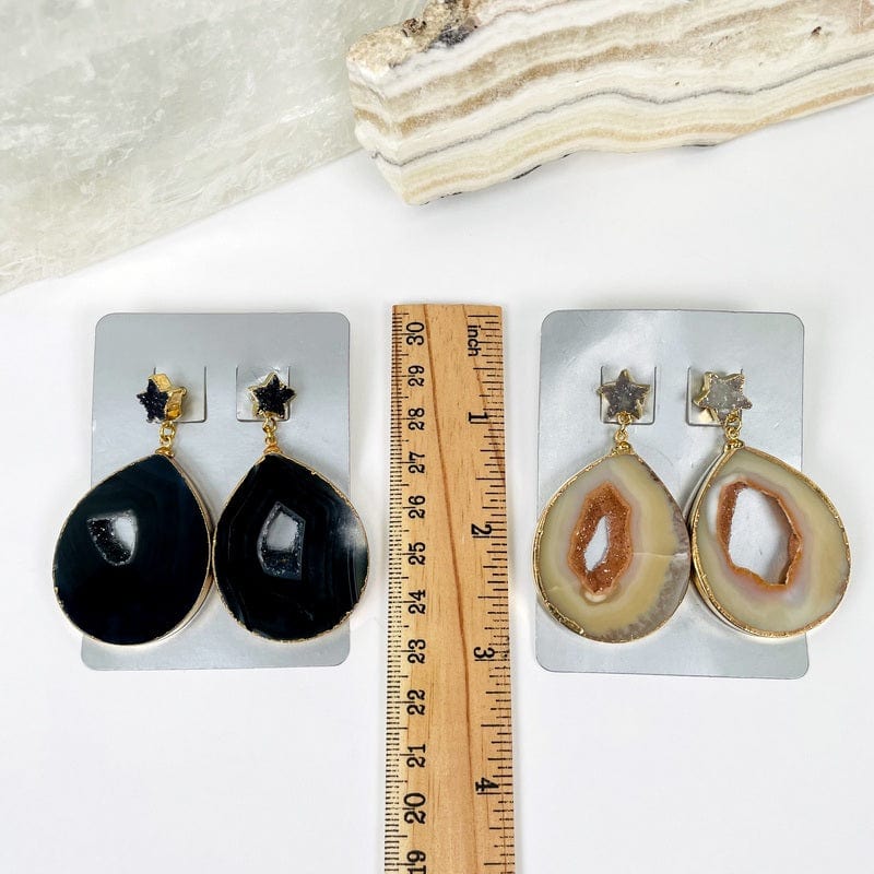 earrings next to a ruler for size reference 