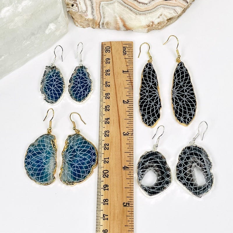 earrings next to a ruler for size reference 