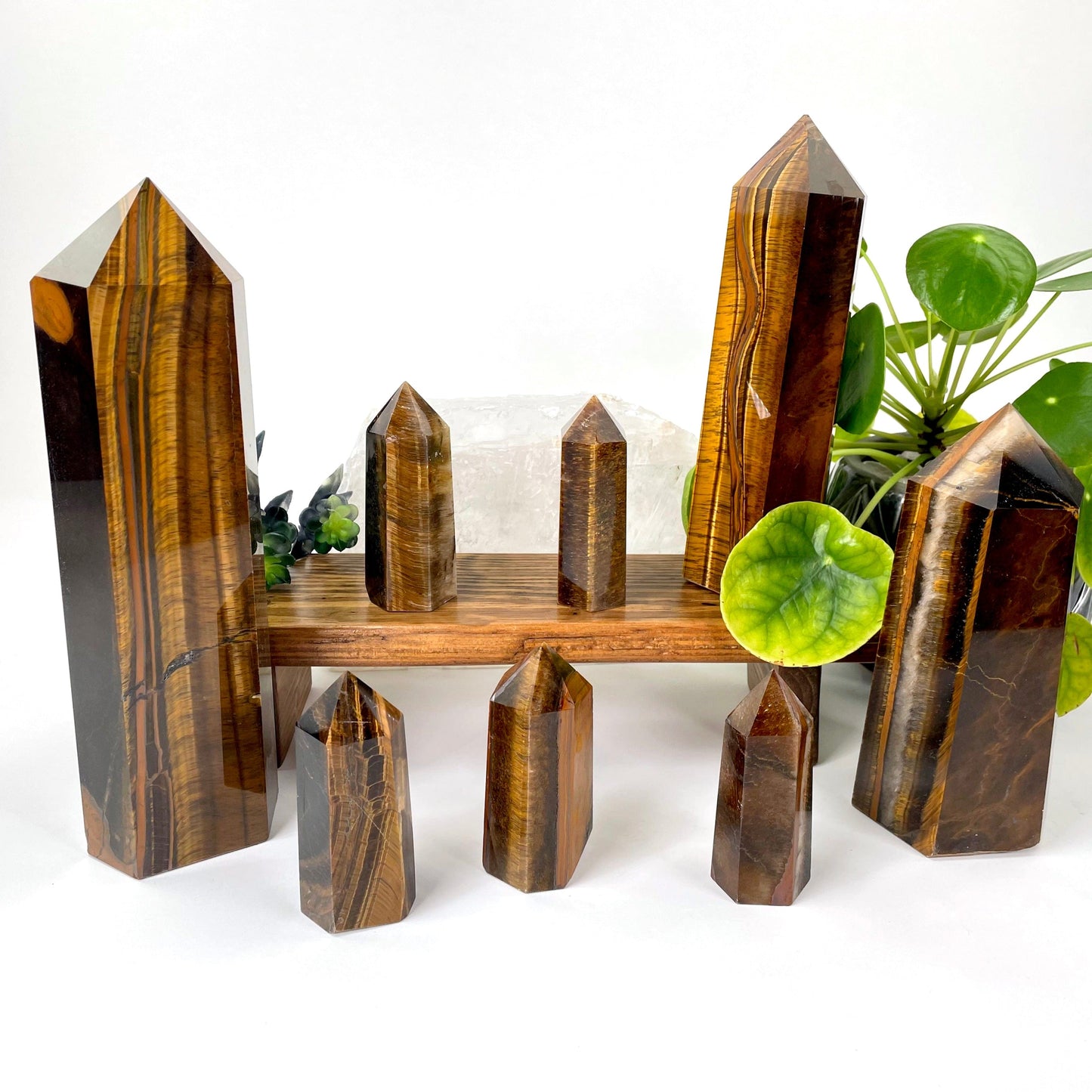 many different tiger eye polished point weights on display