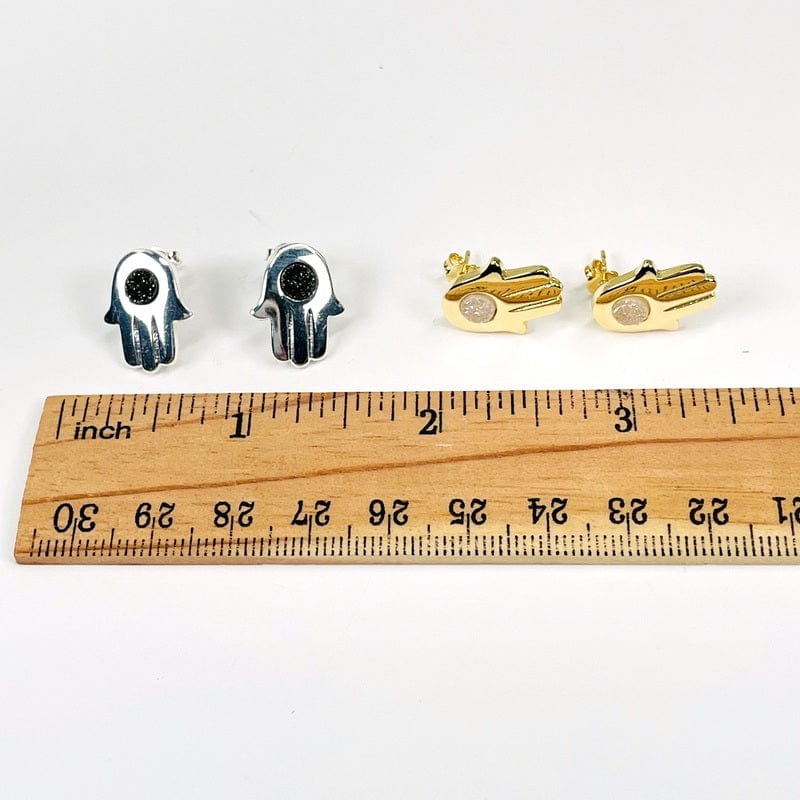 earrings next to a ruler for size reference 