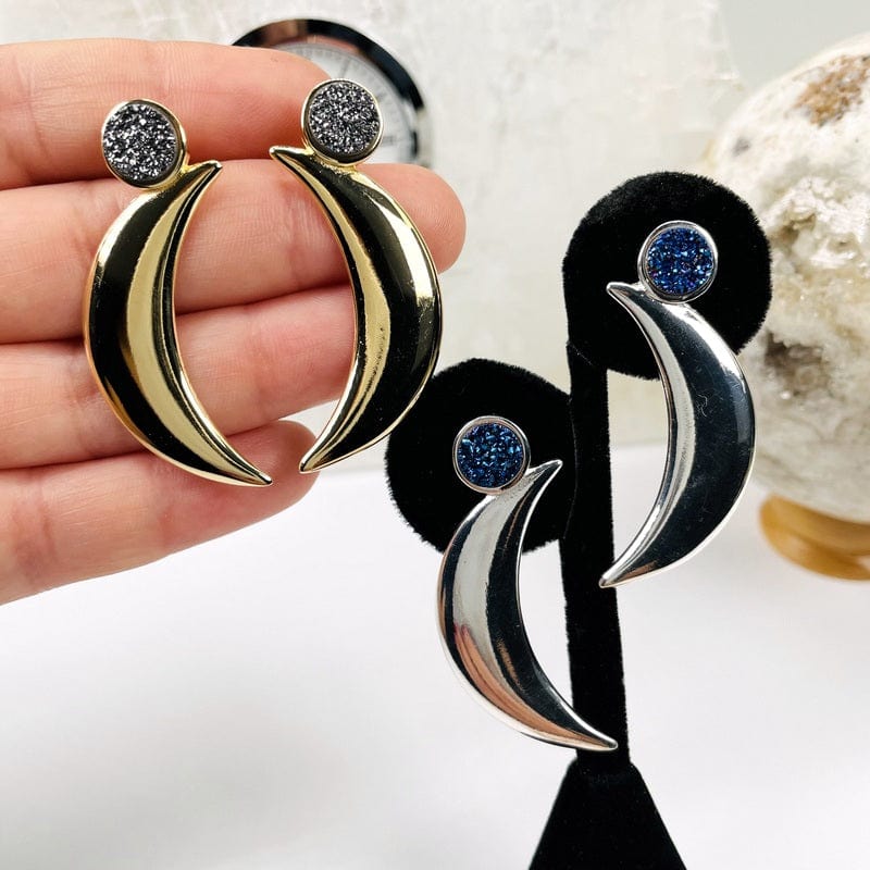 Moon Crescent Earrings with Druzy Accent shown here in gold and silver and in a hand for size reference