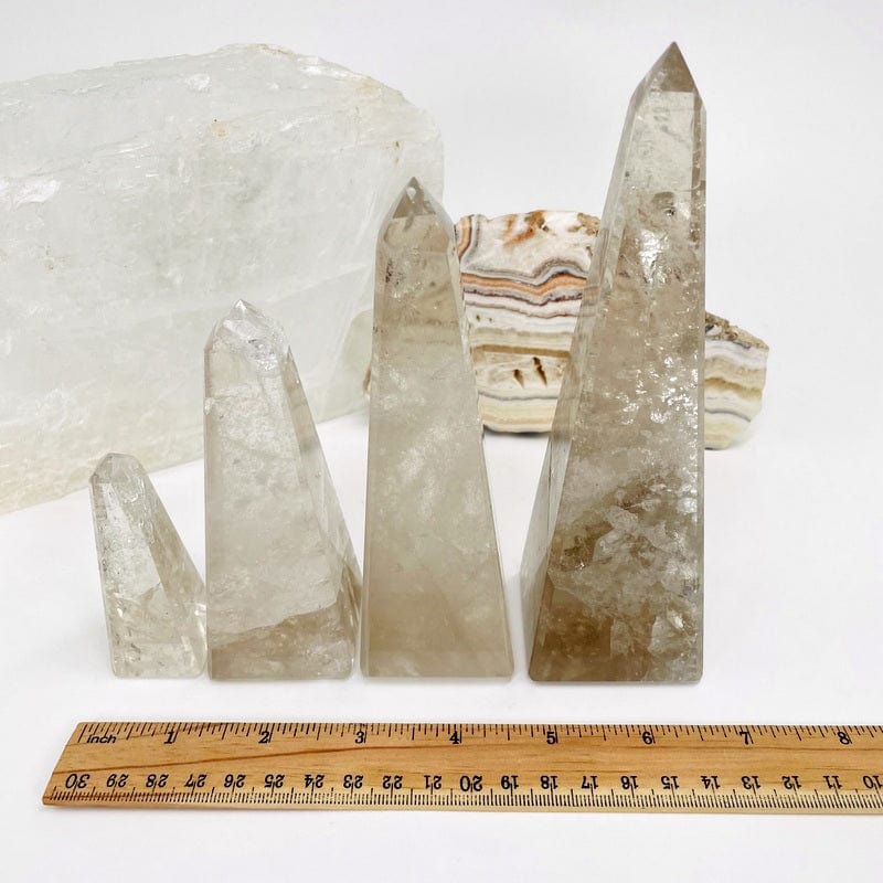 smokey quartz obelisk next to a ruler for size reference 
