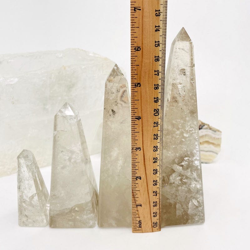 smokey quartz obelisk next to a ruler for size reference 
