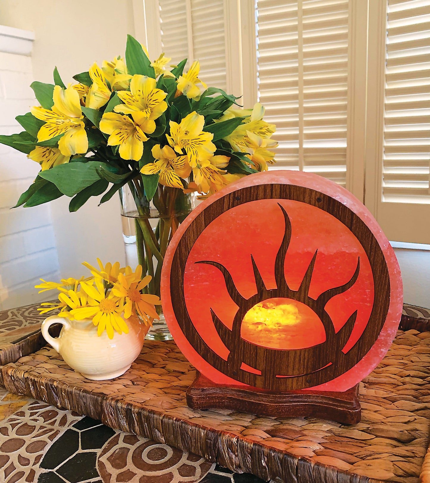 Himalayan Salt Lamp with the flaming sun design, lit and on display