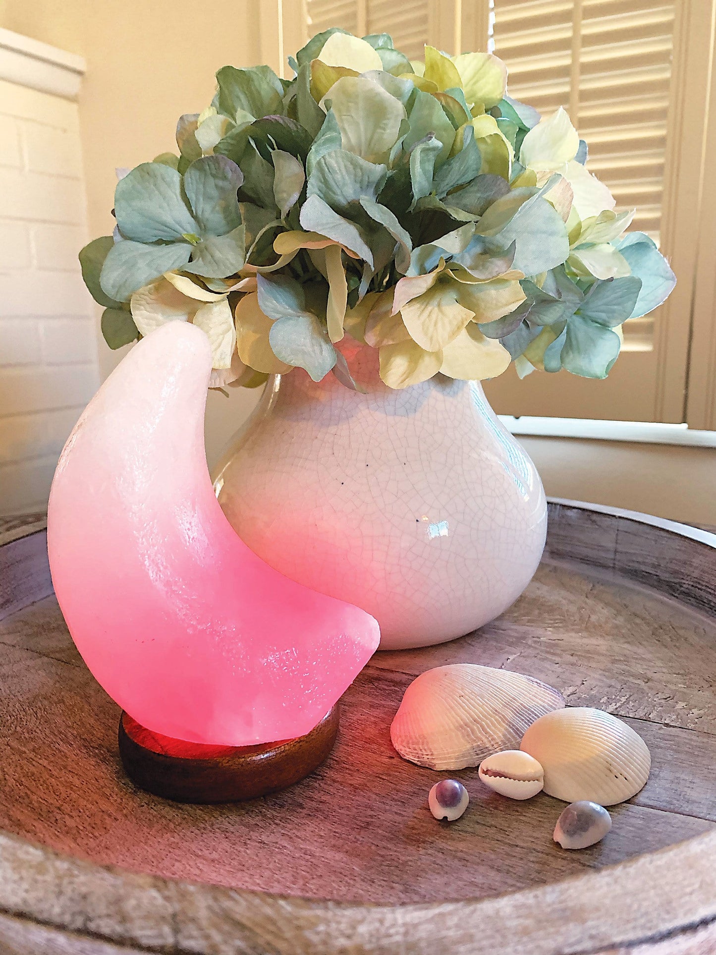 Moon shaped Himalayan Salt Lamp showing the changing color light, here in red