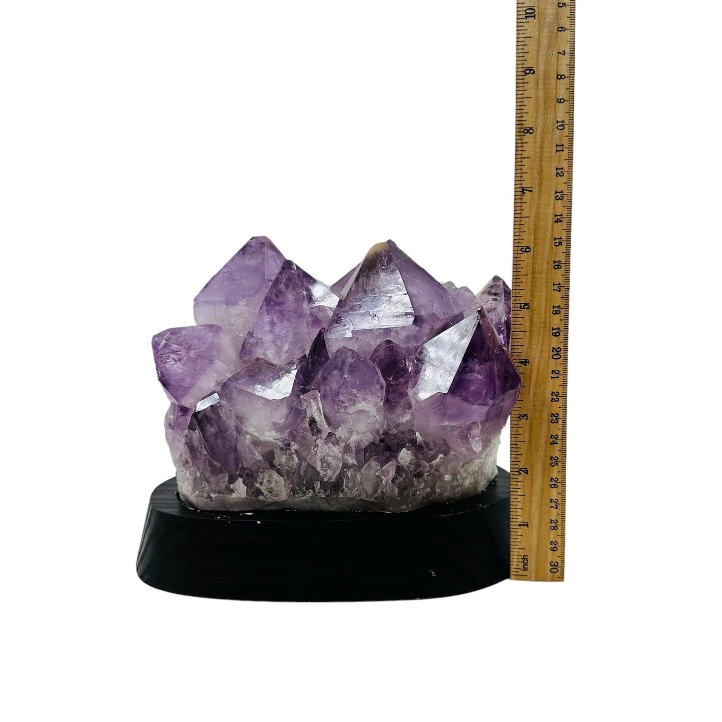 amethyst cluster next to a ruler for size reference 