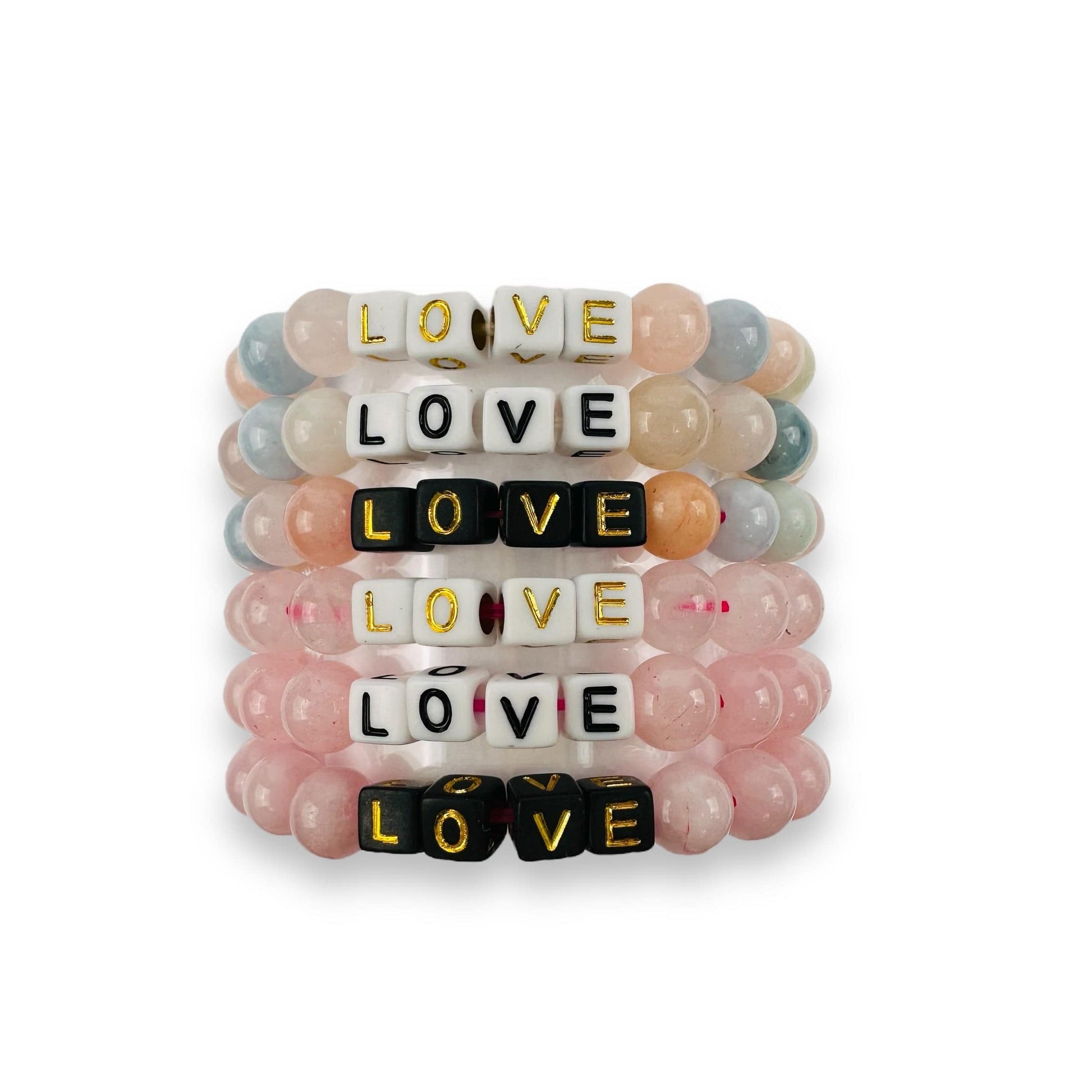 Crystal Mala Bead Bracelet -LOVE -  Letter Beads Bracelets shown here stacked showing rose quartz and morganite beads with the letters in gold and black on white and black letter beads