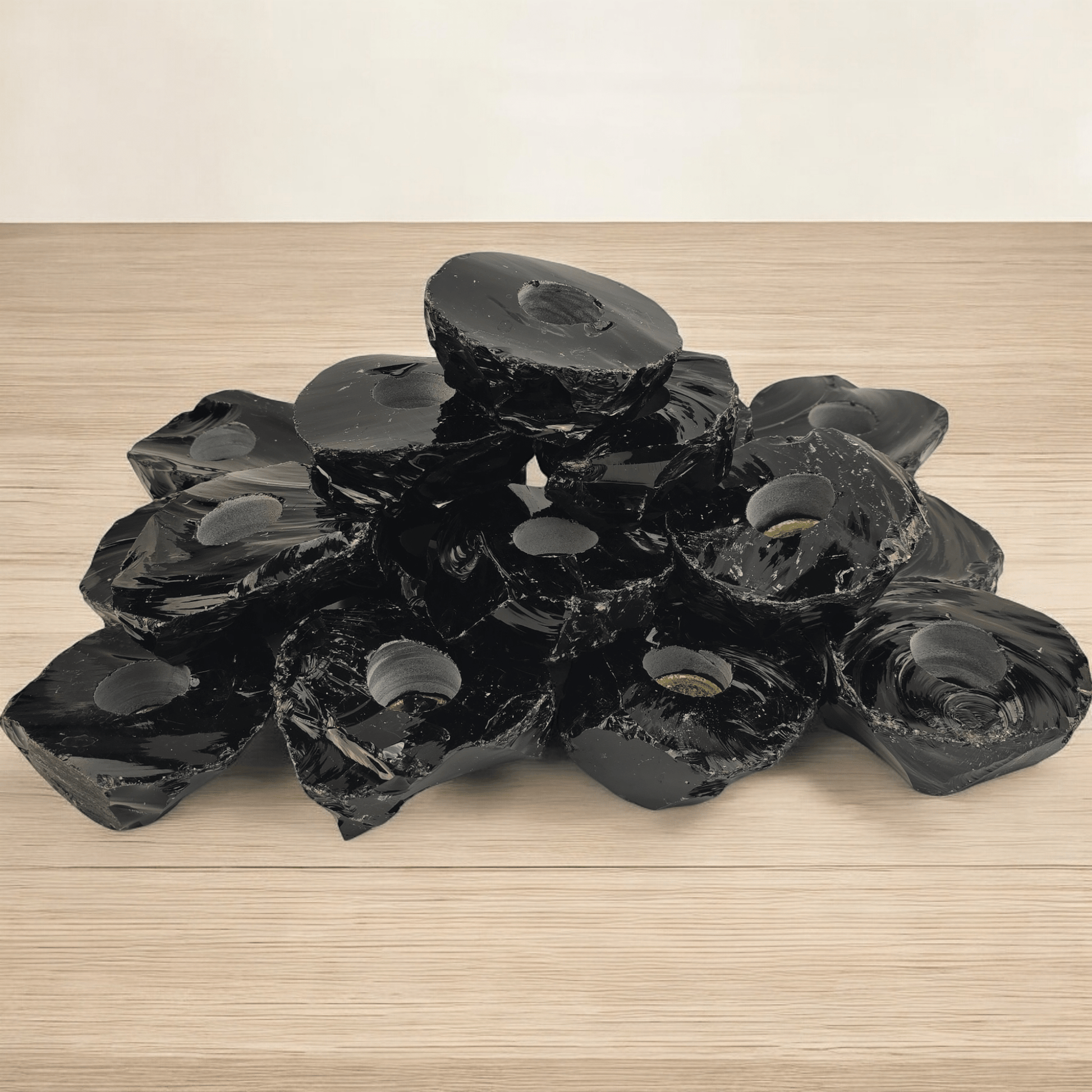 Black Obsidian Candle Holder - Pack of 20 Crystal Candle Holders - Wholesale Bulk Deal side view stacked on wooden surface