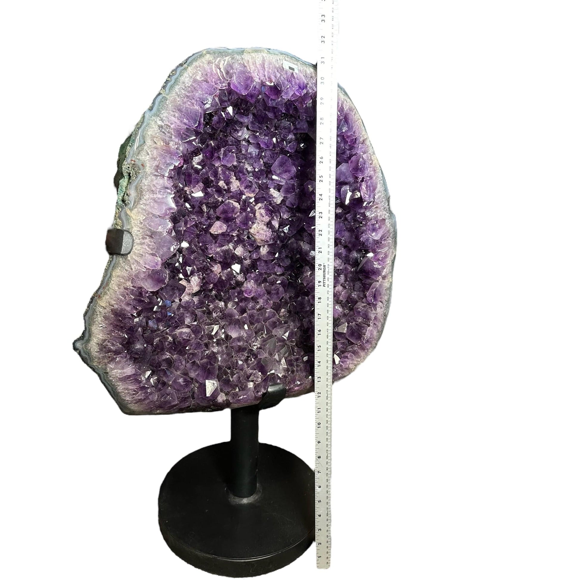 amethyst next to a ruler for size reference 