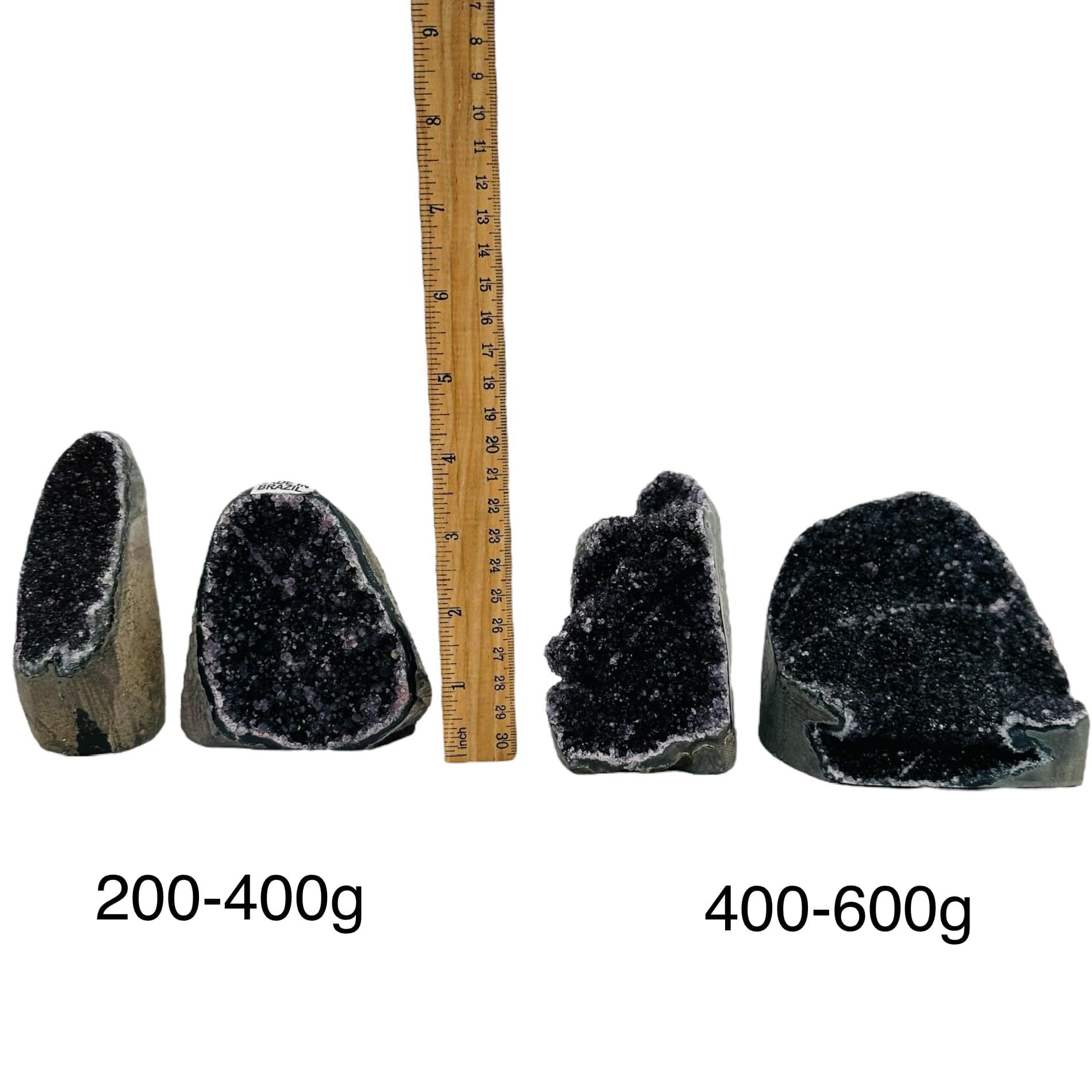 black amethyst druzy cut base crystals next to a ruler for size reference. sold by weight 