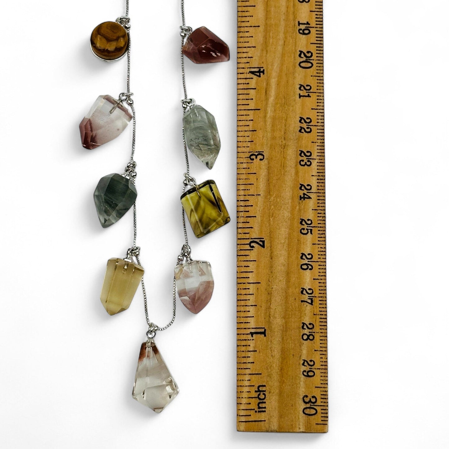 charms next to a ruler for size reference 