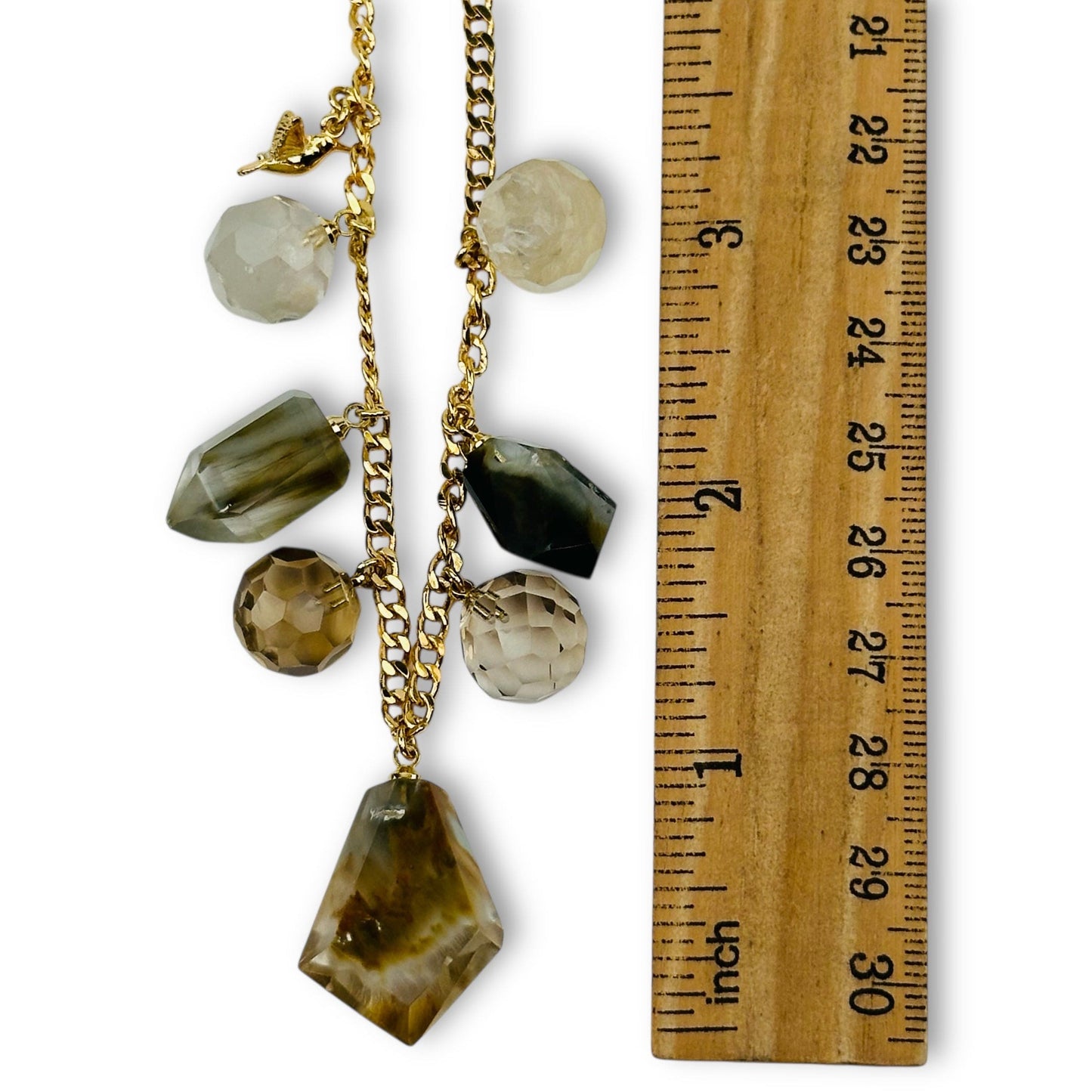necklace crystal charms next to a ruler for size reference 