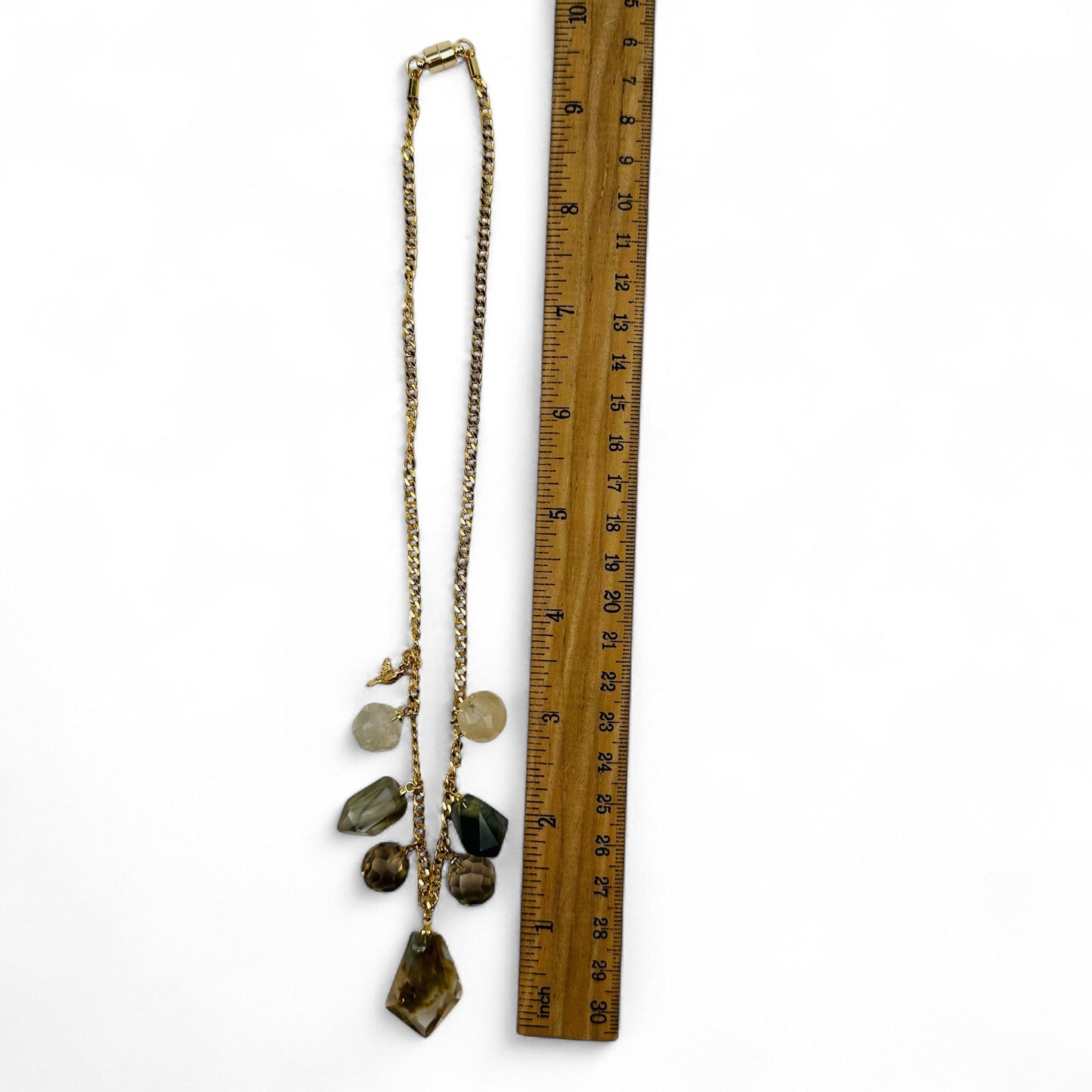 necklace displayed next to a ruler for size reference 