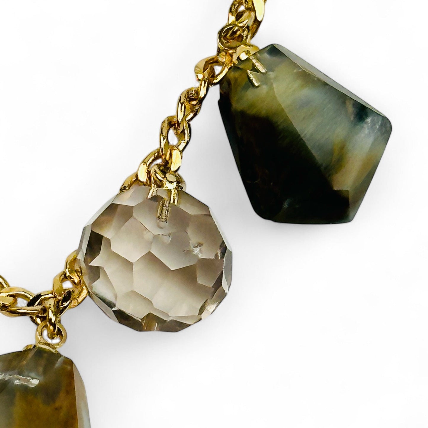 close up of the crystal charms on this gold chain necklace 