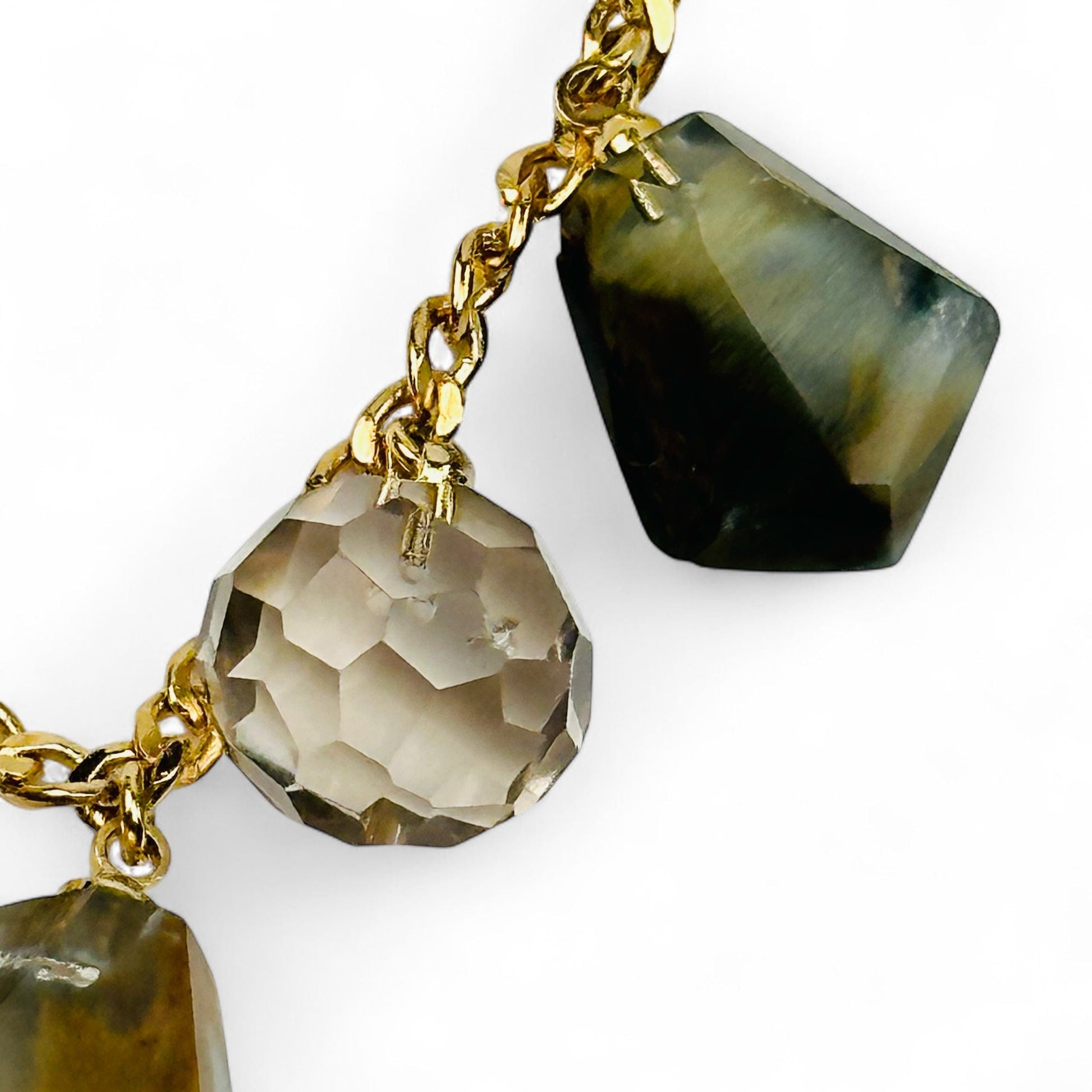 close up of the crystal charms on this gold chain necklace 
