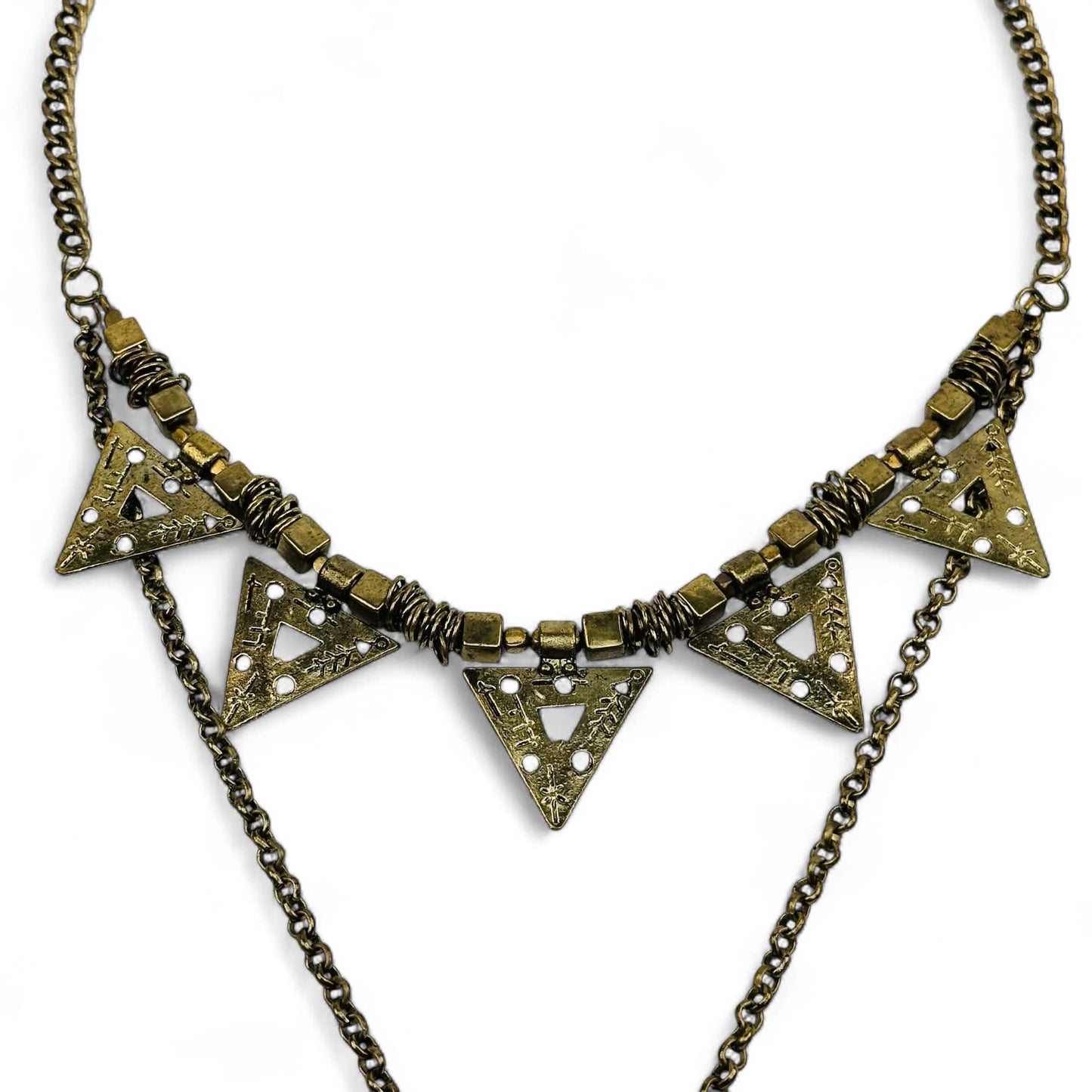 close up of the brass charms hanging off this necklace 
