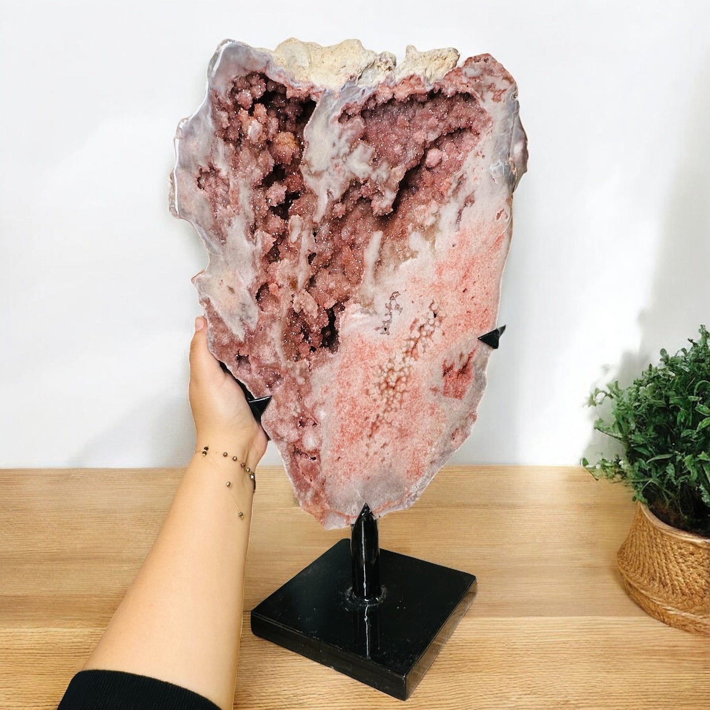 pink amethyst crystal on metal stand displayed as home decor 