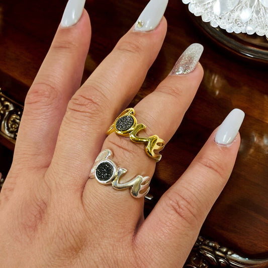 druzy ring with the word love on hand for size reference 