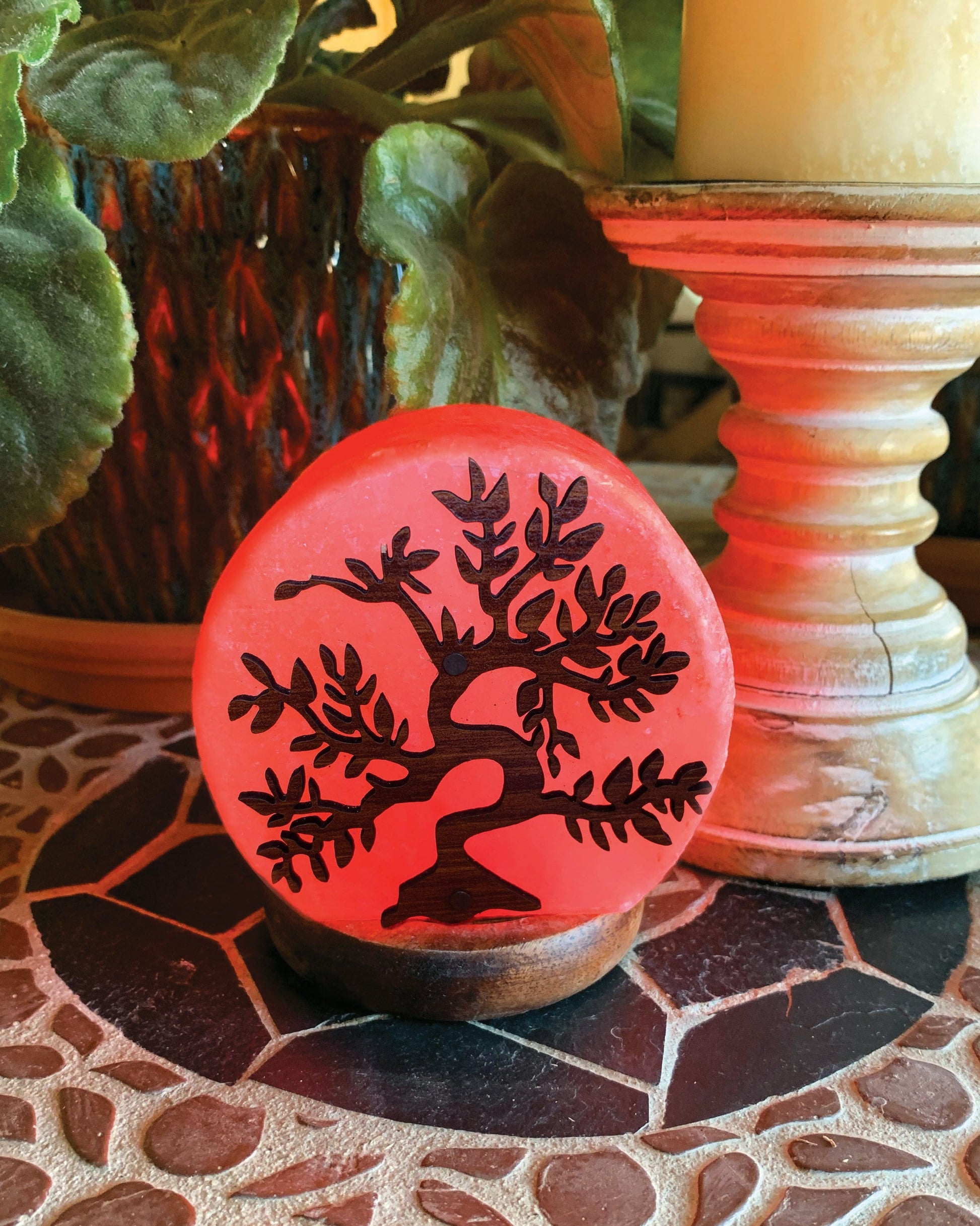himalayan salt lamp with a tree lit up as home decor 