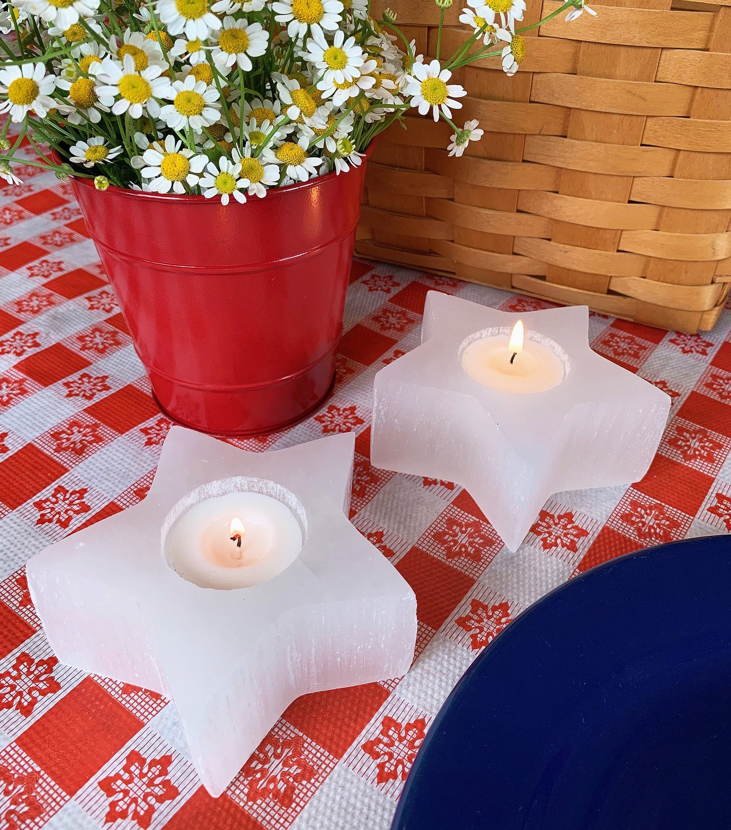 two selenite star candle holders on display with candles (not included with purchase)