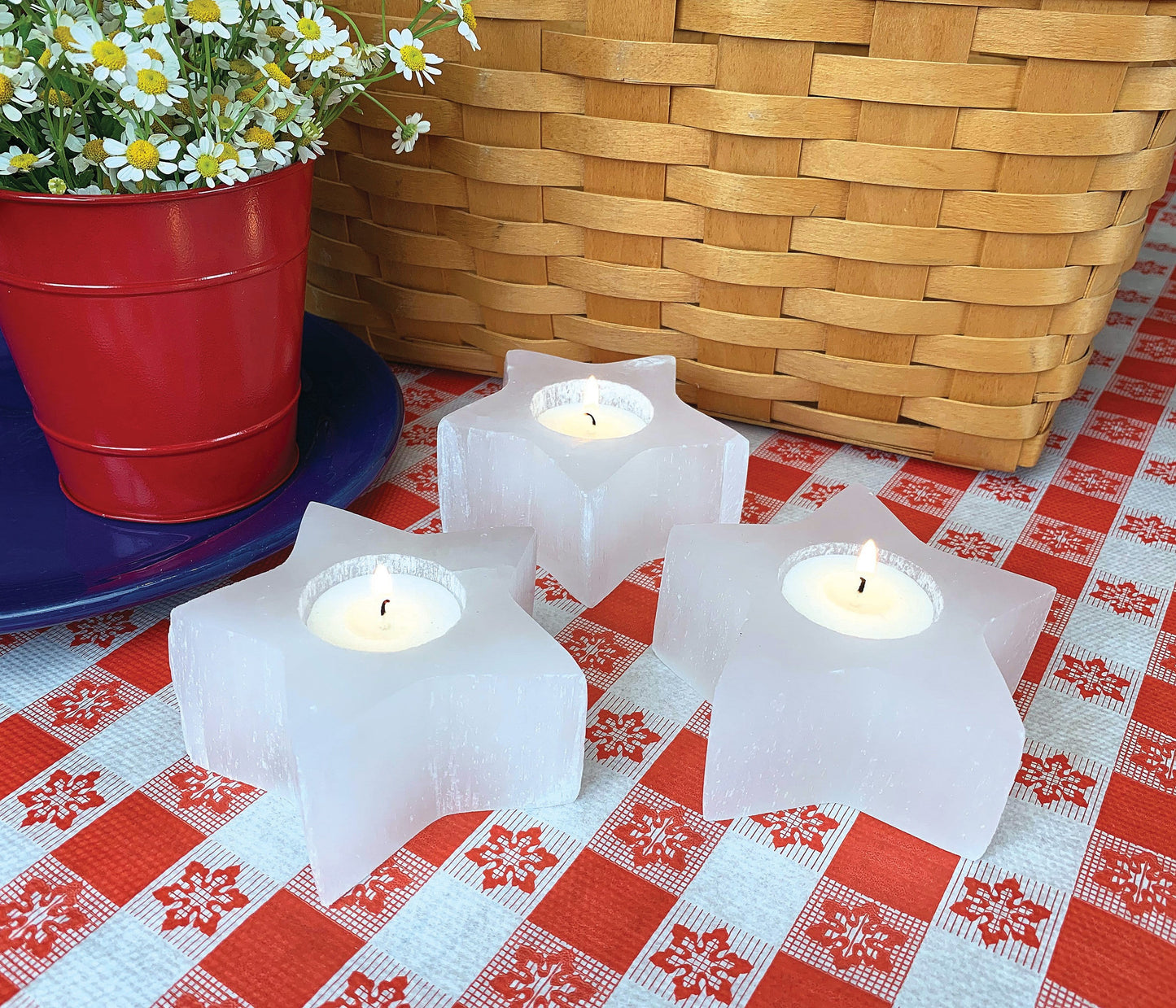 three selenite star candle holder on display with candles (not included with purchase) 
