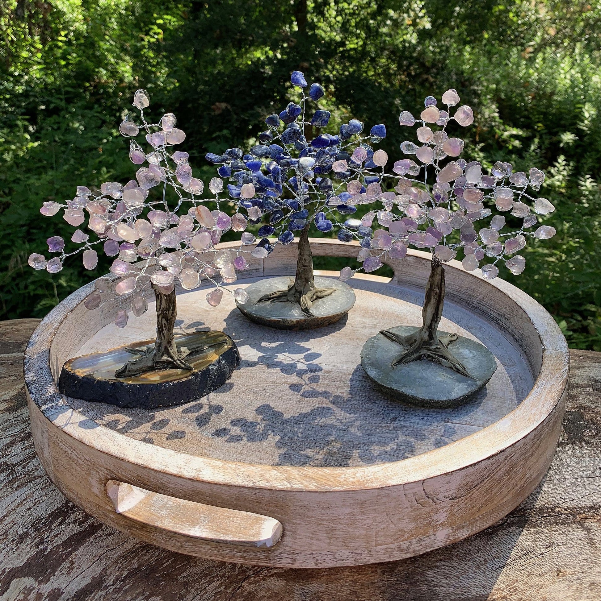 Tumbled Stone Trees on Agate Slab - 3 on a table